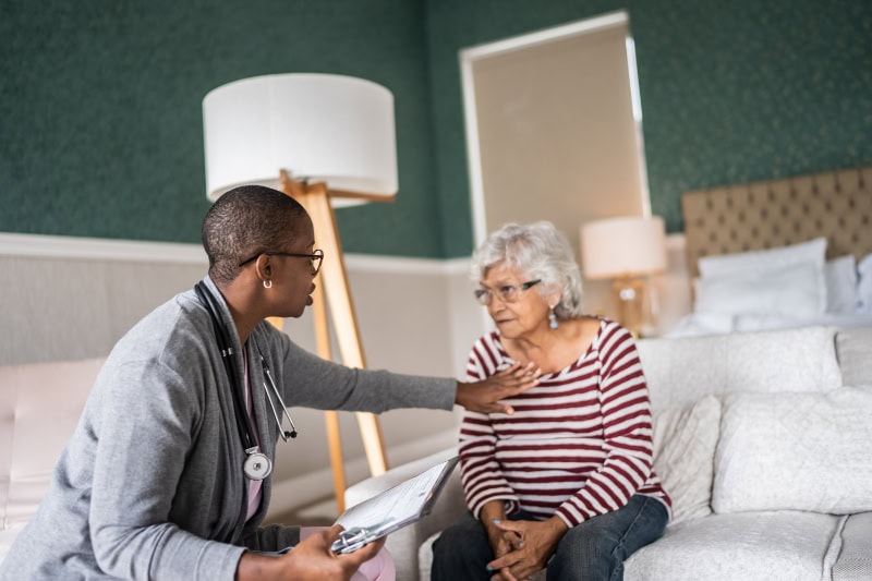 A doctor giving an older woman a checkup